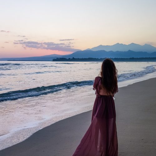 picture of a woman in long dress on the beach