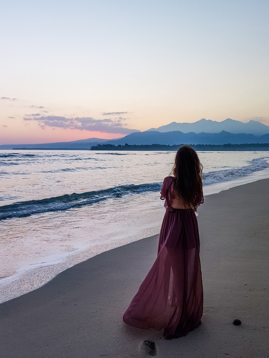 picture of a woman in long dress on the beach