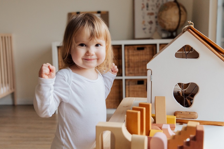 picture of a baby girl playng with toys
