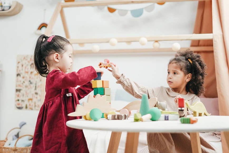 picture of two little girls playing with toys 