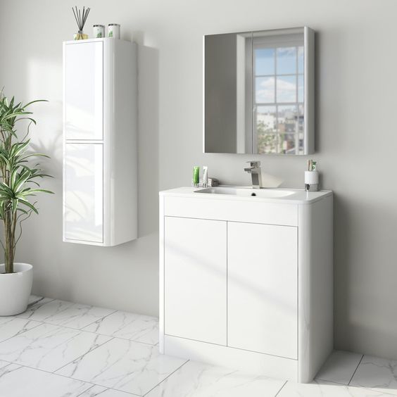 white basin with vanity with cabinets