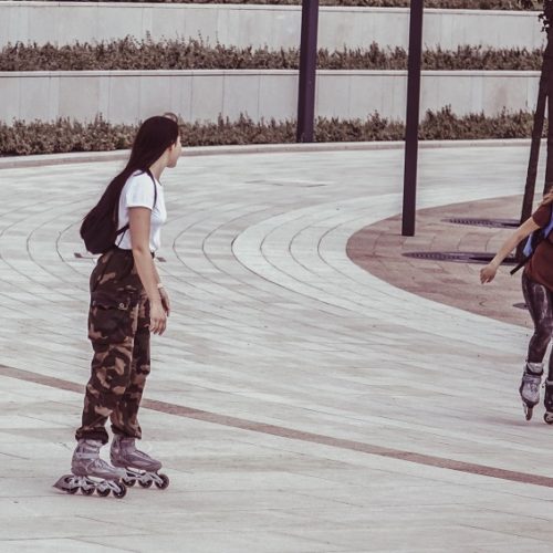 picture of two girls riding roller blades in a park