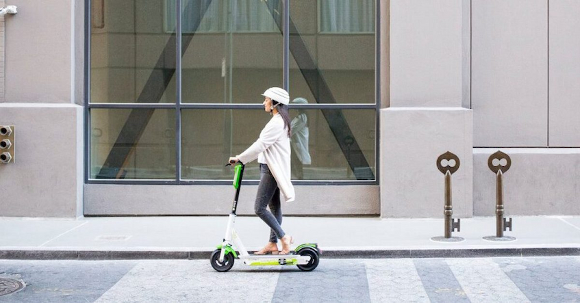 Women riding scooter in city