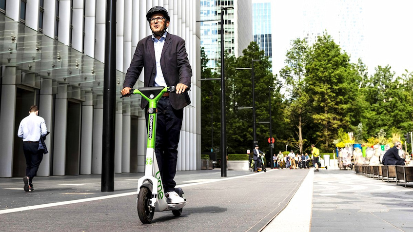 Man riding scooter