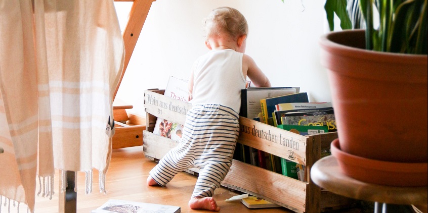 baby looking at books and magazines 