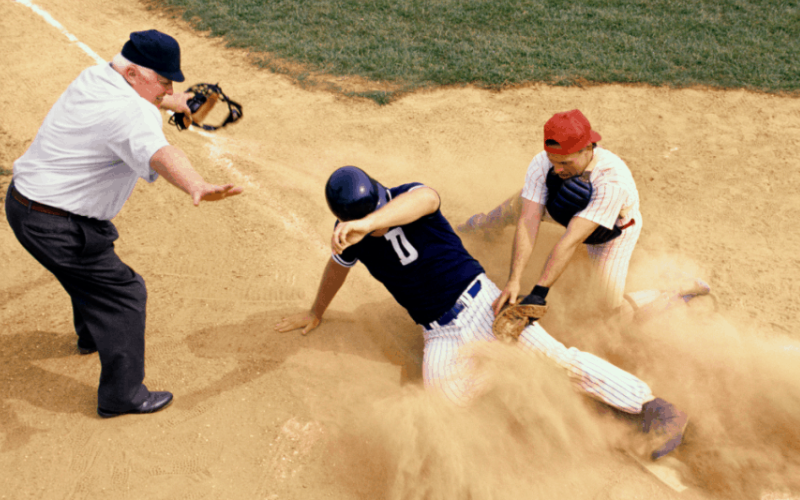 Baseball player sliding in the sand