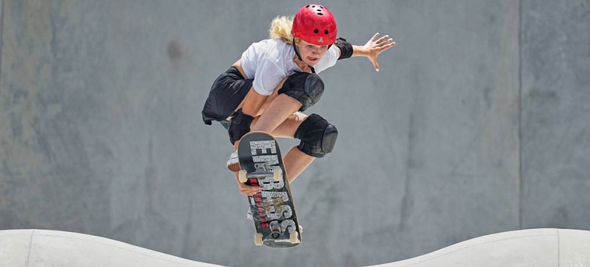 picture of a girl skateboarding with protective gear