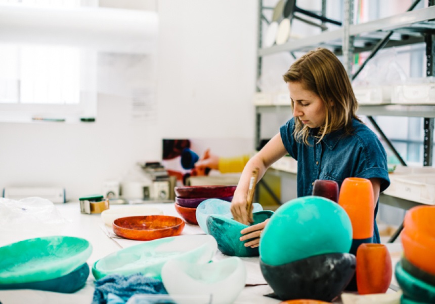 woman working on resin designer luxury dinnerware