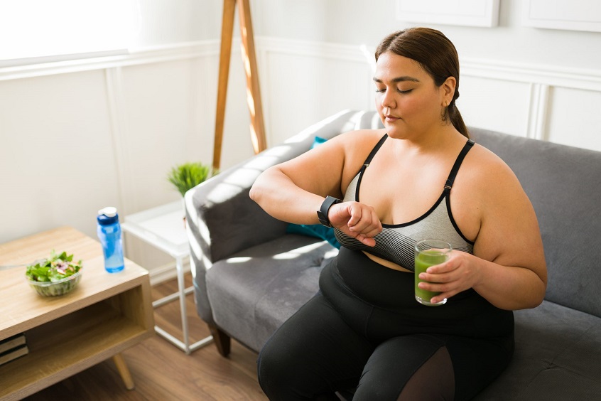 overweight woman holding a protein smoothie
