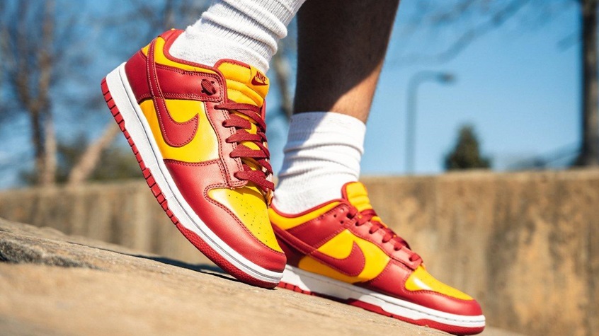 person wearing red and yellow coloured nike dunks