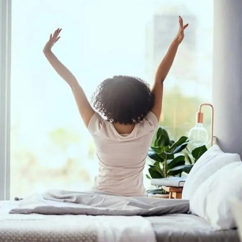 Woman waking up on perfect mattress