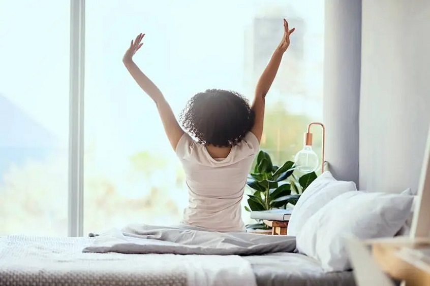 Woman waking up on perfect mattress