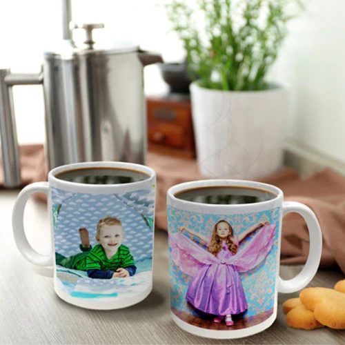 2 mugs with photos of kids on a table